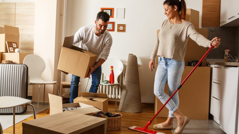 Young couple cleaning and selecting things at they new home.Moving house.