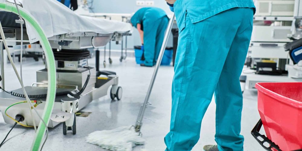 woman-cleaning-staff-mopping-the-floor-of-a-hospital-operating-room.jpg